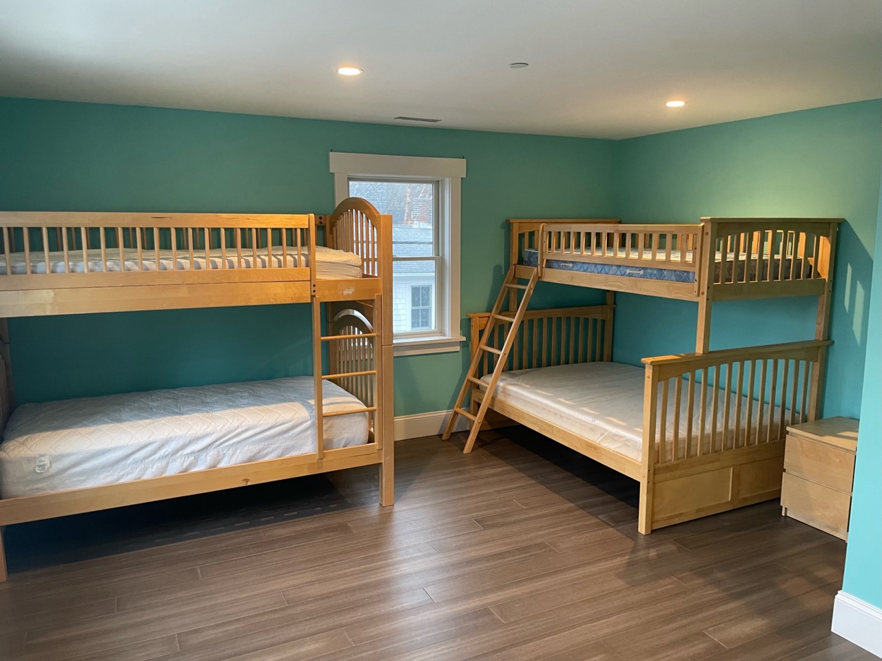 Spacious blue bedroom with two wooden bunk beds
