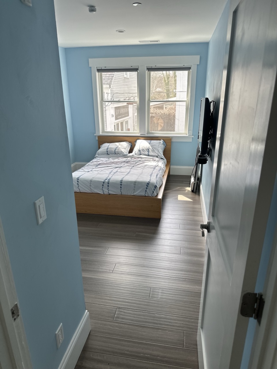 Calm blue guest bedroom with a double bed